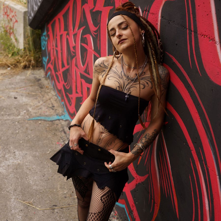 People wear Avanyah - Avanyah’s black steampunk-inspired tube top and mini skirt, modeled as part of a bold alternative fashion and festival outfit