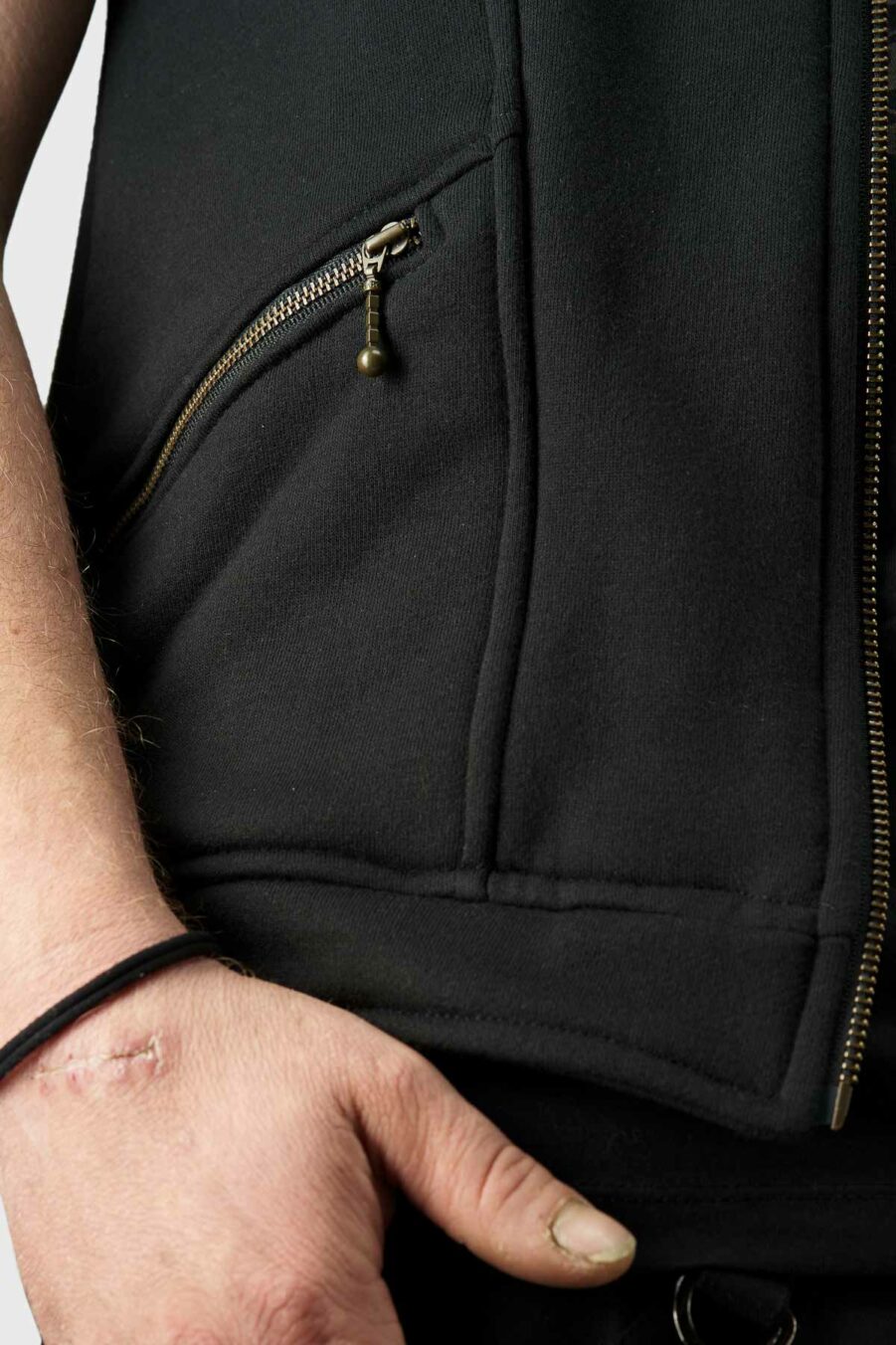 hooded-tan-thora-vest-for-men-in-black-with-handmade-screen-print-alternative-streetwear-zip-pocket