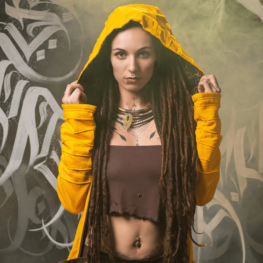 Instagram spotlight: Model in Avanyah’s brown steampunk mini skirt, matching tube top, and screen-printed hoodie – unique festival fashion and expressive alternative wear.