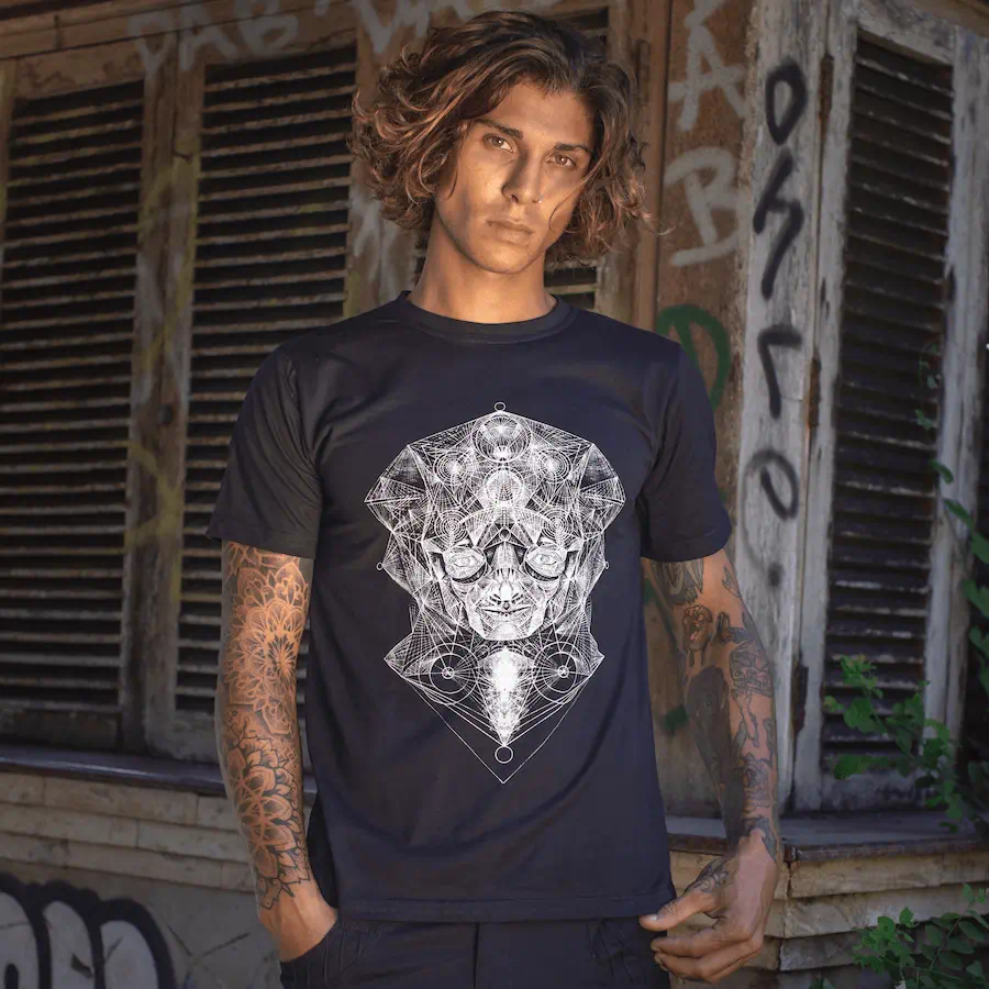 Festival fashion by Avanyah — black cotton t-shirt with Geo Face screen print from the art collective’s exclusive collection, blending wearable art and alternative fashion for men.